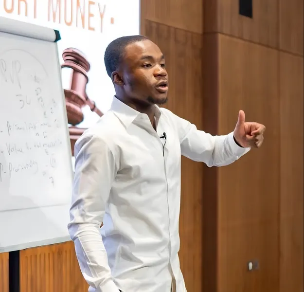 Fawaz Ishola presenting at a whiteboard