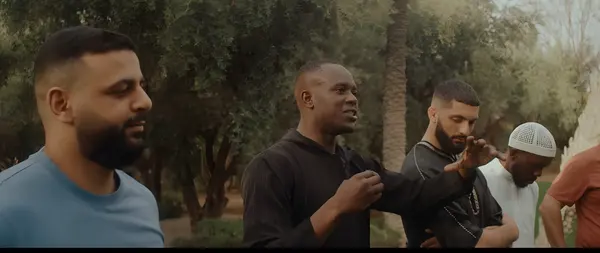 A discussion outdoors under olive trees